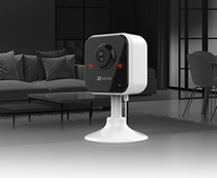HortonBe EZVIZ H1C Home Smart Security Camera showing full HD 1080P footage with lens and mounting bracket in a home setting.